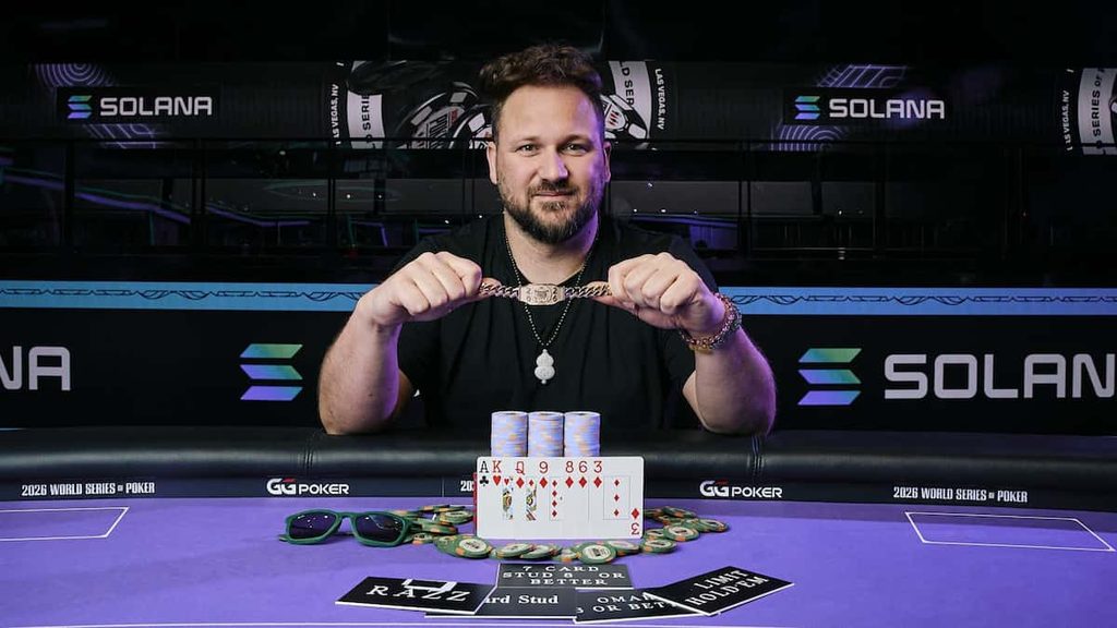 Calvin Anderson holds up a WSOP bracelet.