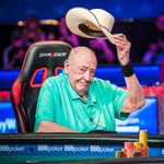 Doyle Brunson lifts his hat to acknowledge a photographer.